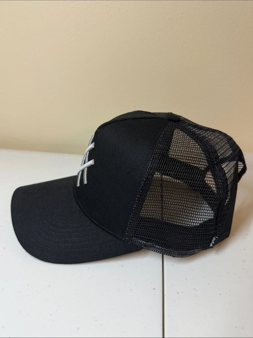 Lucid FC Black Trucker Hat with Silver Embroidered Geometric Logo, Rihanna style